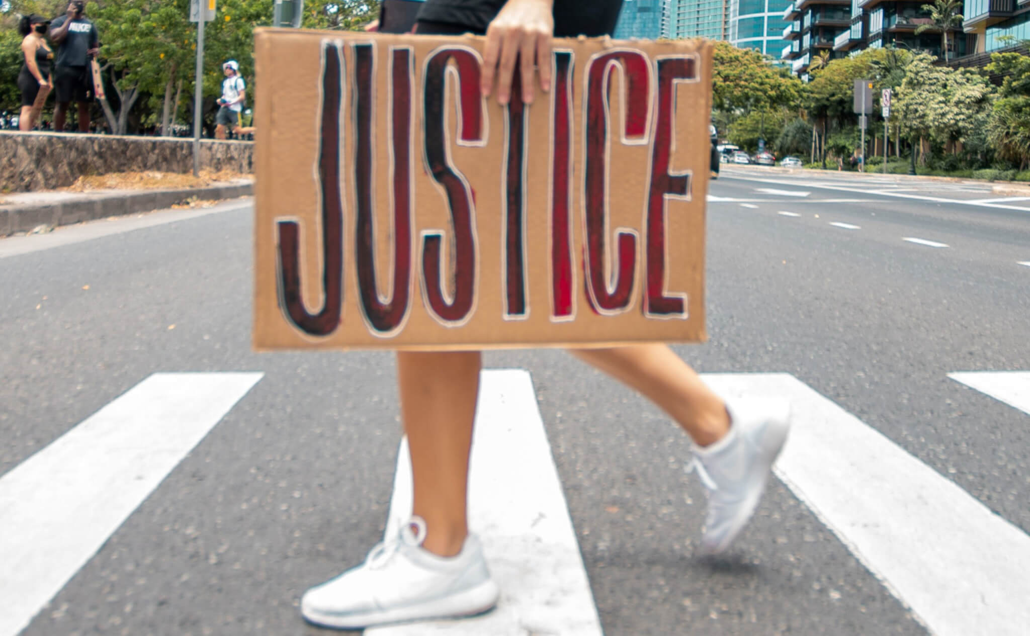 young person carrying a JUSTICE sign